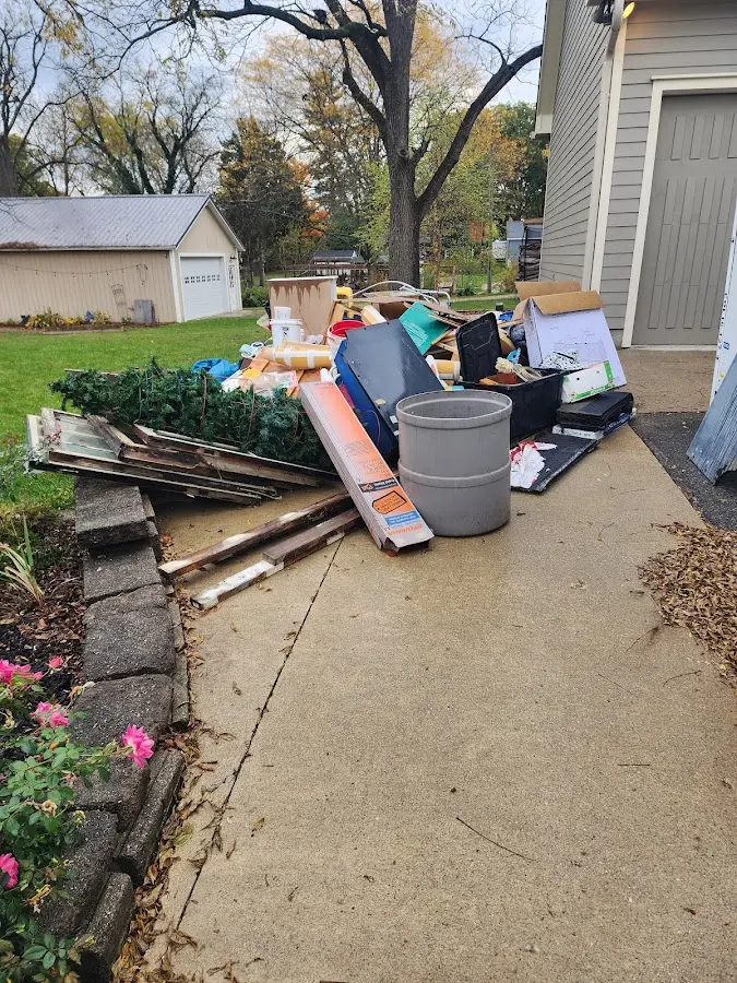 Dumpster being loaded with debris for Estate Cleanout Dumpster Rental in Woodbury